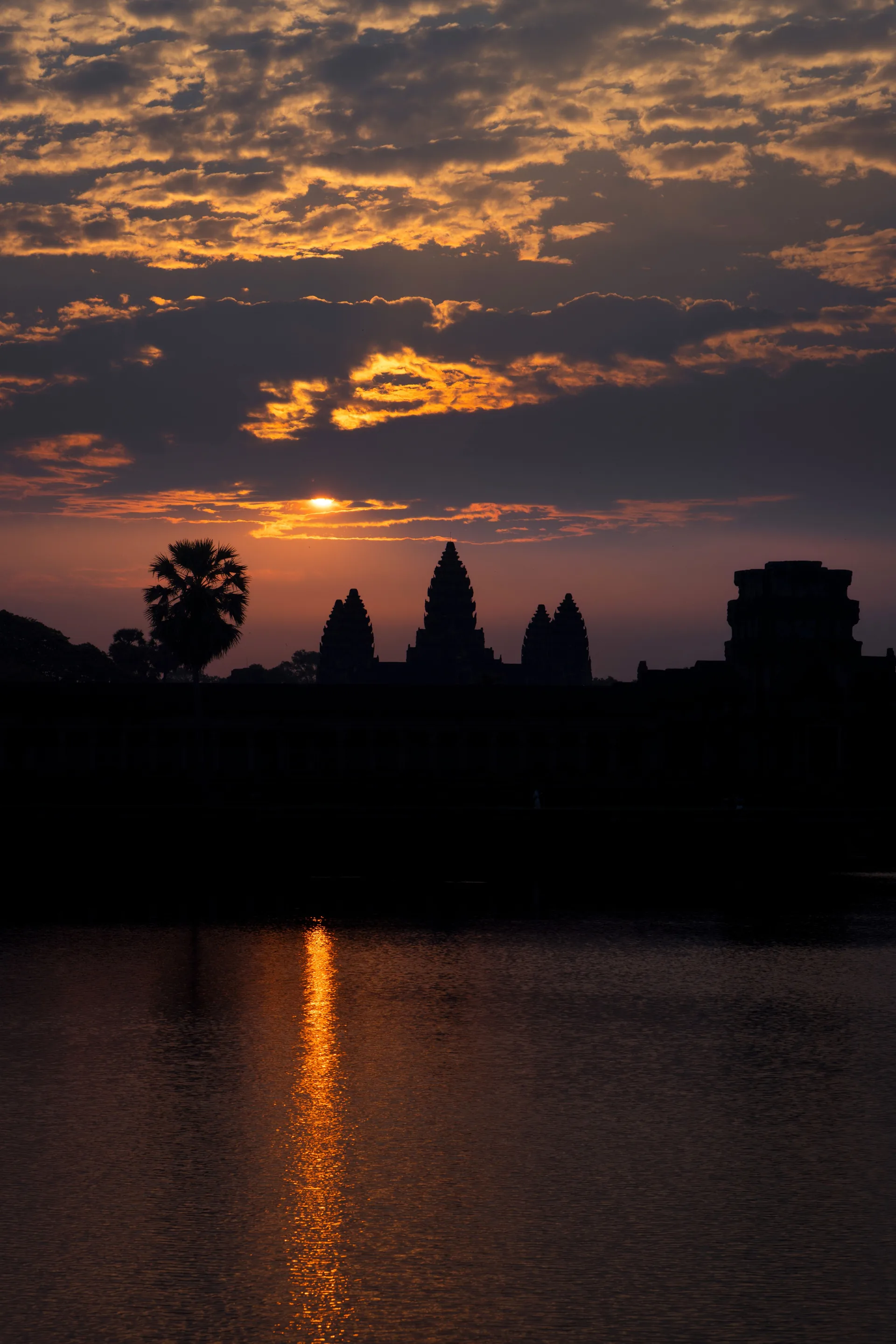 Angkor Wat’s towers silhouetted against a golden sunrise sky