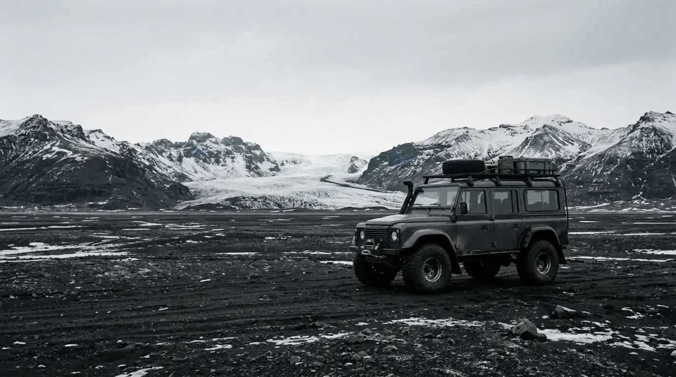 Interpretive AI-created illustration of a modified high-clearance four-wheel-drive vehicle alone on a vast black volcanic sand plain in winter
