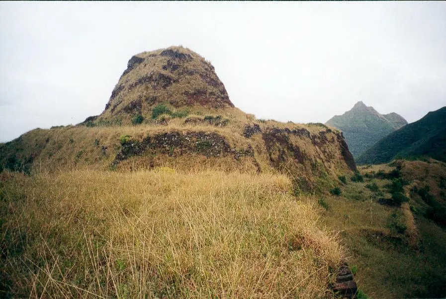 A prominent grass-covered fortified hill on Rapa Iti