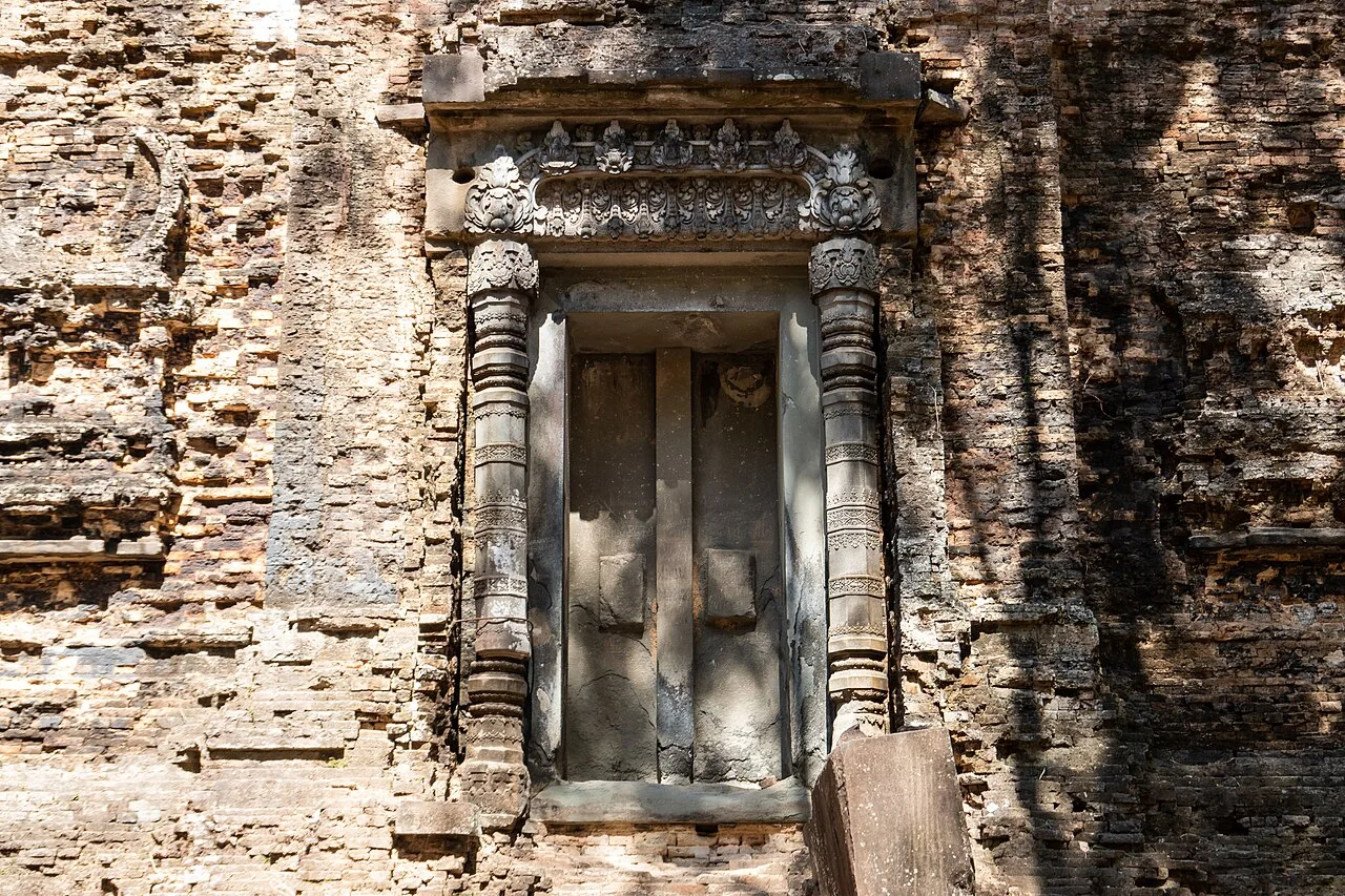 Carved stone frame and decorative lintel set within brickwork at Sambor Prei Kuk