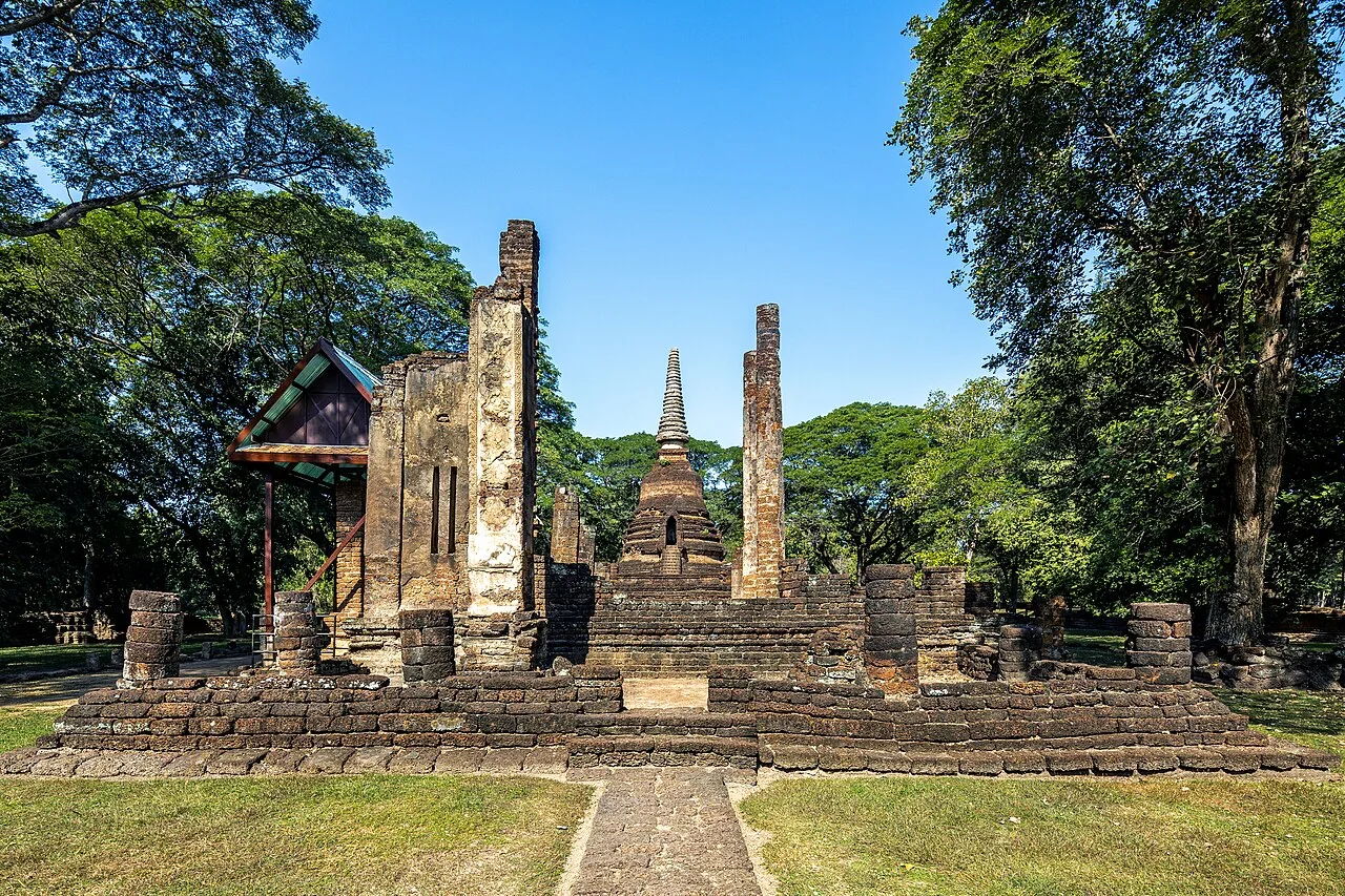 Wat Nang Phaya with surviving walls and a chedi among trees
